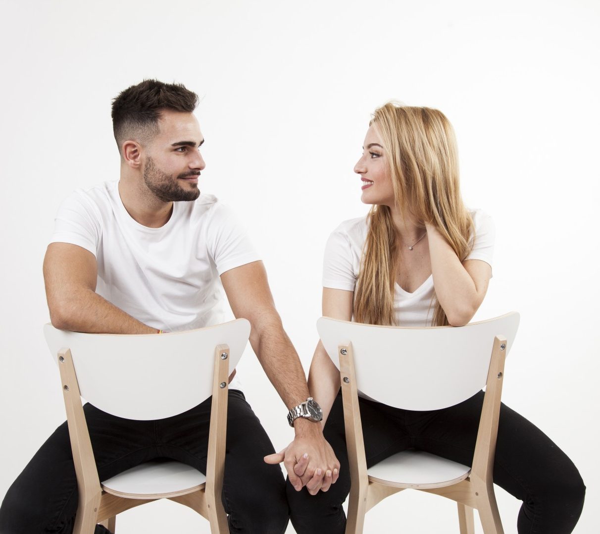 Couple Chairs Holding Hands E1721731939799